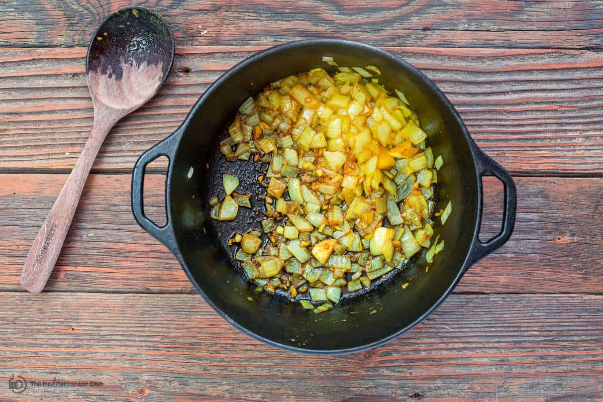 Onions and garlic sauteed in a Dutch oven 